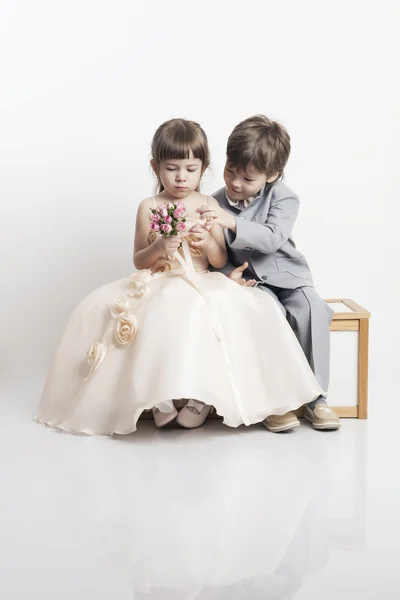 Портрет двух красивых маленьких мальчиков и девочек в Свадебные платья — стоковое фото
